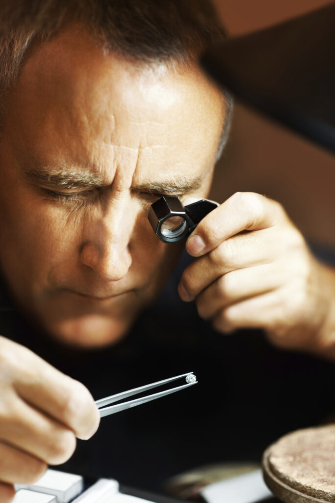 Contrôle minutieux d’une pierre précieuse à l’aide d’outils de précision dans un environnement d’expertise.